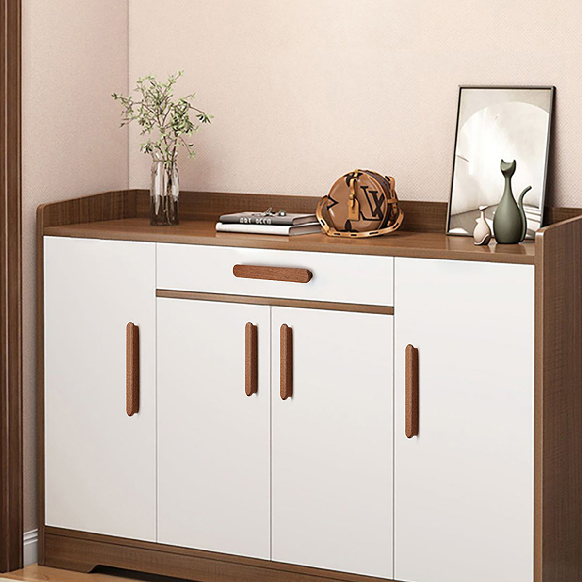 In-use view of slim rounded reddish wood finger pull, 64 mm option.