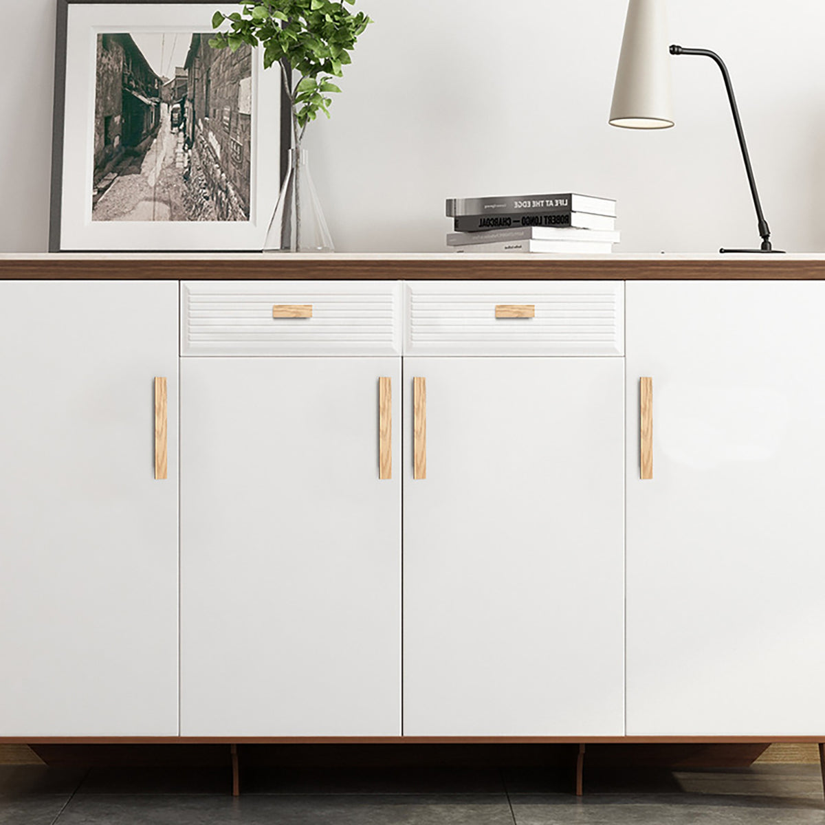 Natural oak wood finger pulls fitted to a white sideboard.