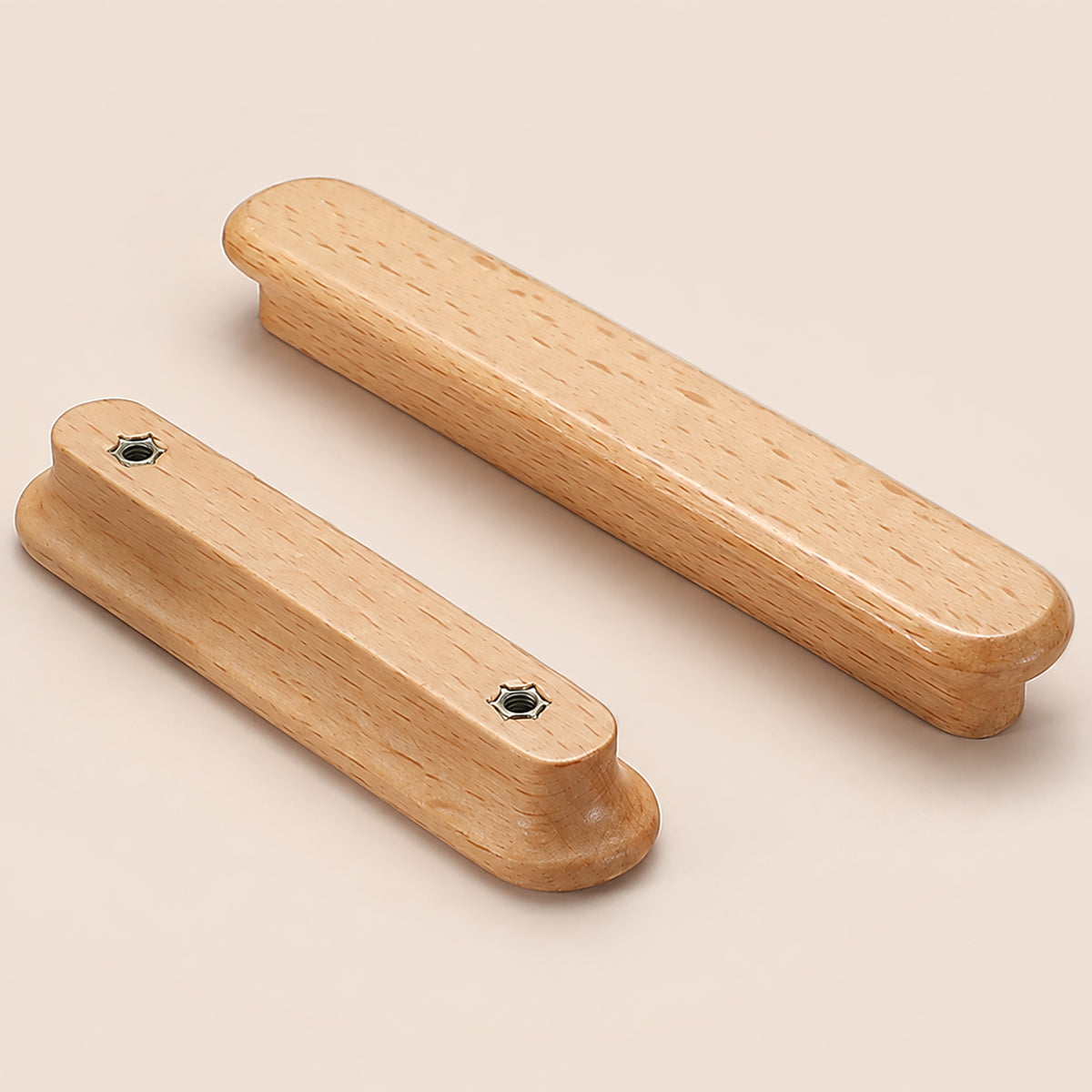Two beech wood finger pulls, showing front and back mounting holes.