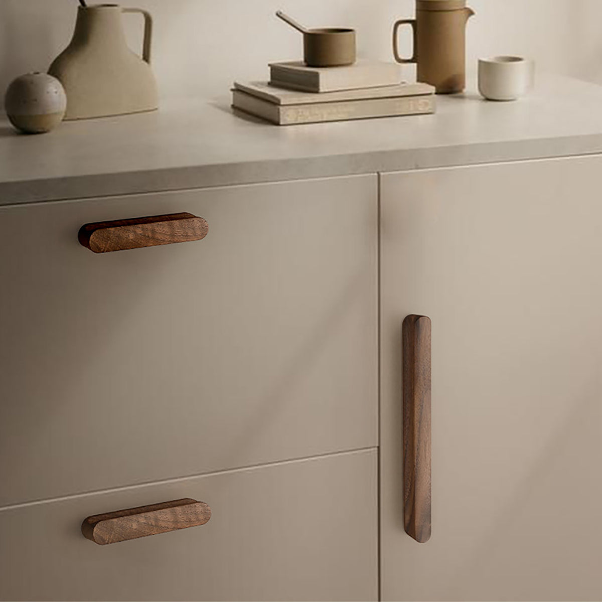 Walnut wood cabinet finger pull (128 mm) shown in a styled setting.
