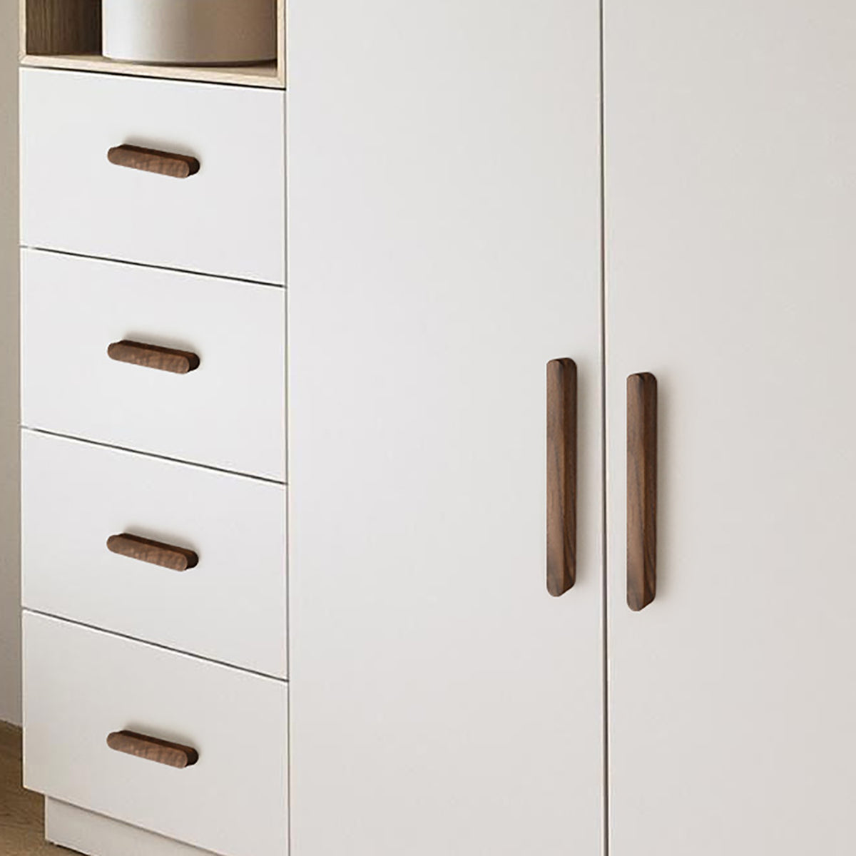 Walnut wood cabinet finger pull (192 mm) shown in a styled setting.