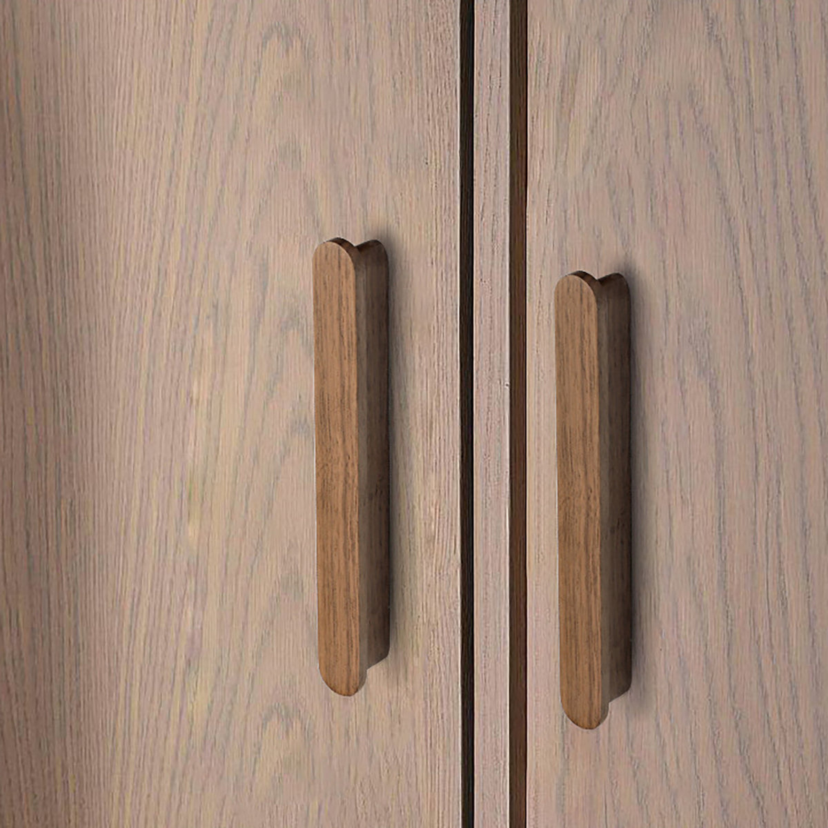 Walnut wood slim cabinet finger pull installed on cabinetry.