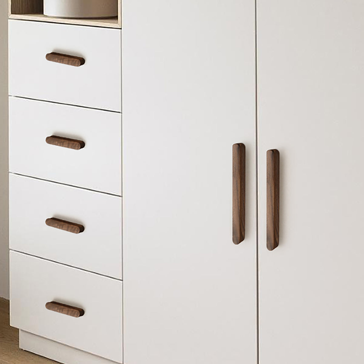 Walnut wood cabinet finger pull (96 mm) shown in a styled setting.