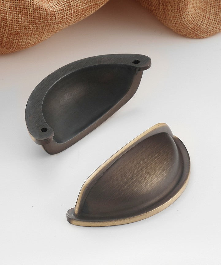 Front and rear views of the solid brass open-back cup pull in Antique Bronze, showing two rear mounting holes.