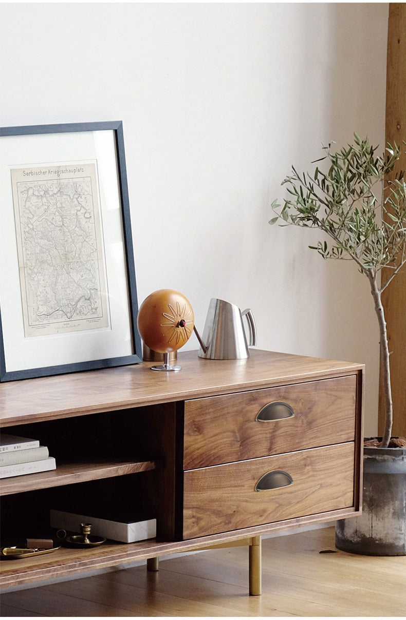 Solid brass open-back cup pulls in Antique Bronze on the drawers of a wood-grain sideboard.