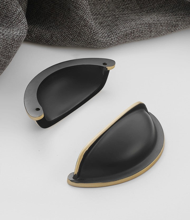 Front and back views of the solid brass open-back cup pull in Blackened Bronze, showing its curved face and two mounting holes.