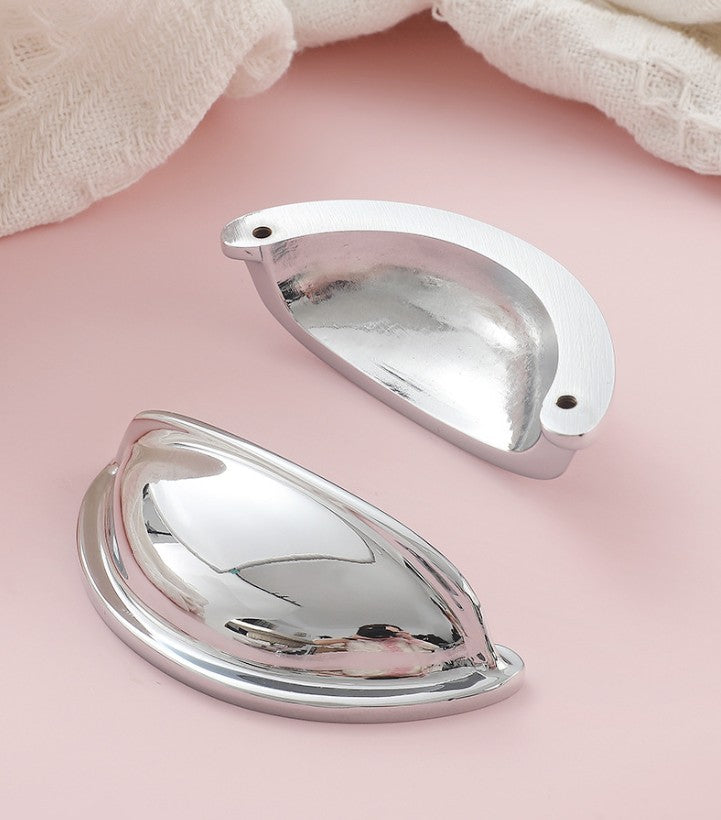 Front and back views of the solid brass open-back cup pull in Polished Chrome, showing its reflective face and two mounting holes.