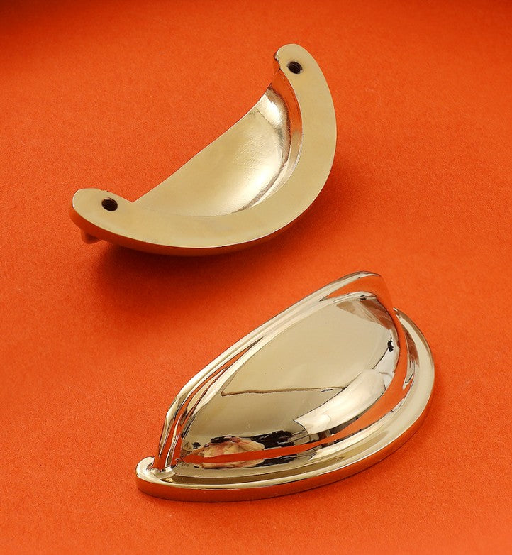 Front and back views of the solid brass open-back cup pull in Polished Gold, showing its reflective face and two mounting holes.