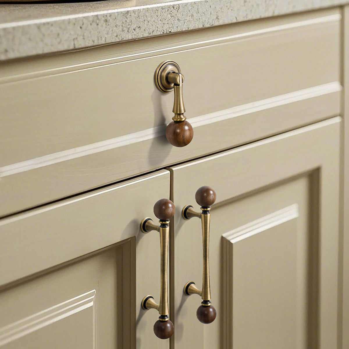 Wood-ended swinging bar brass drop pull with brushed bronze finish, style #12 installed on furniture.