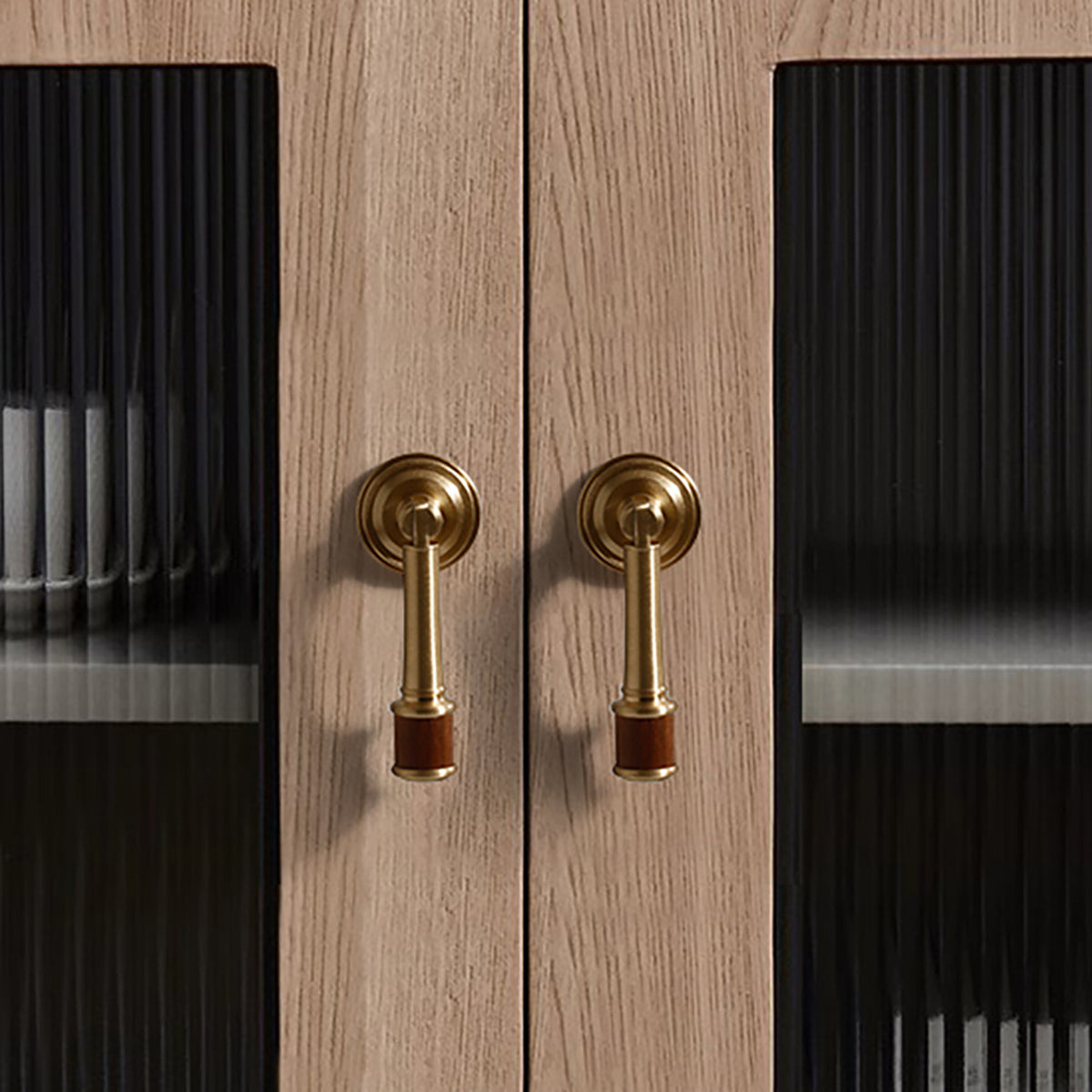 Swinging bar brass drop pull with brushed bronze finish, style #13 installed on furniture.