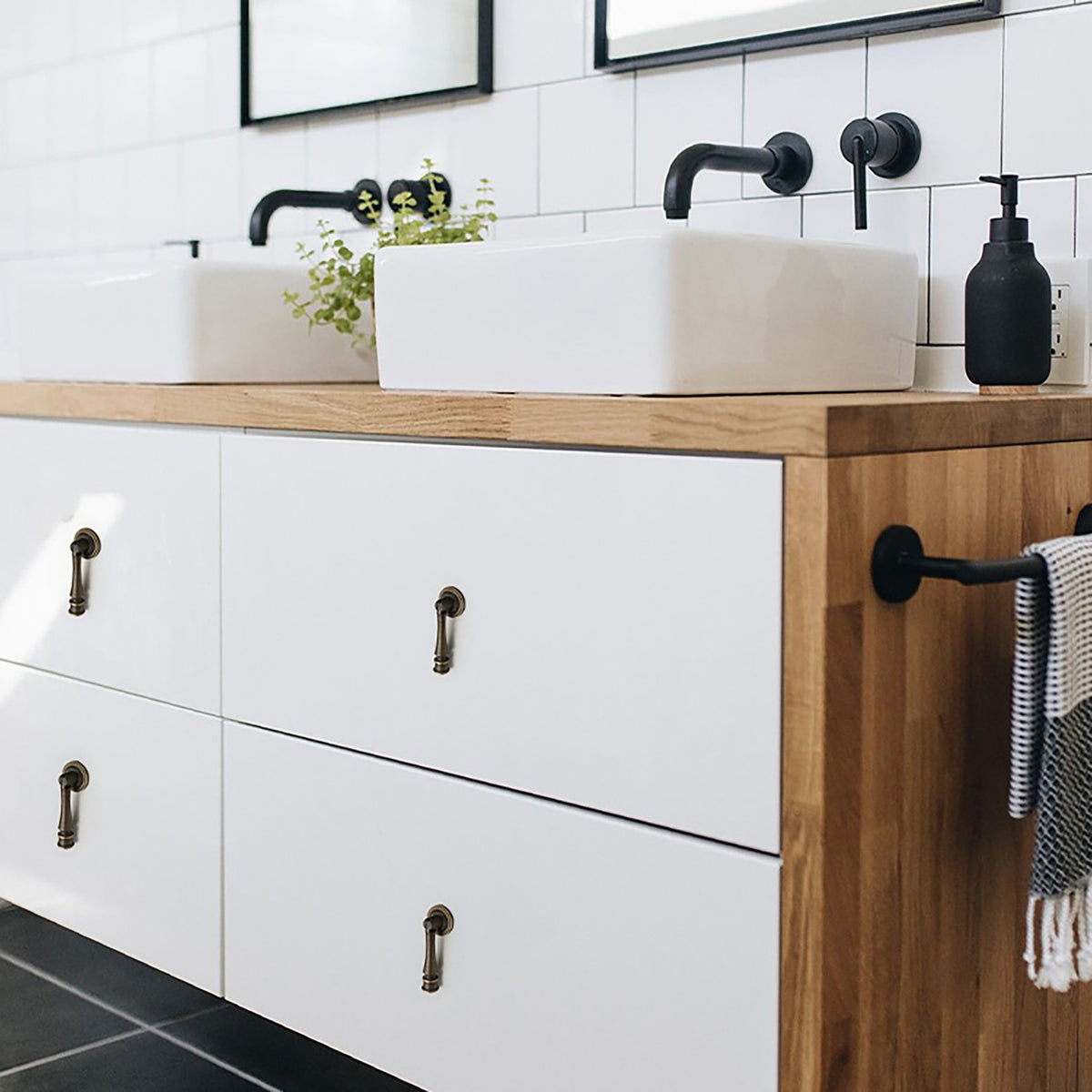 In-use view of tapered antique bronze brass drop pull, style #18.
