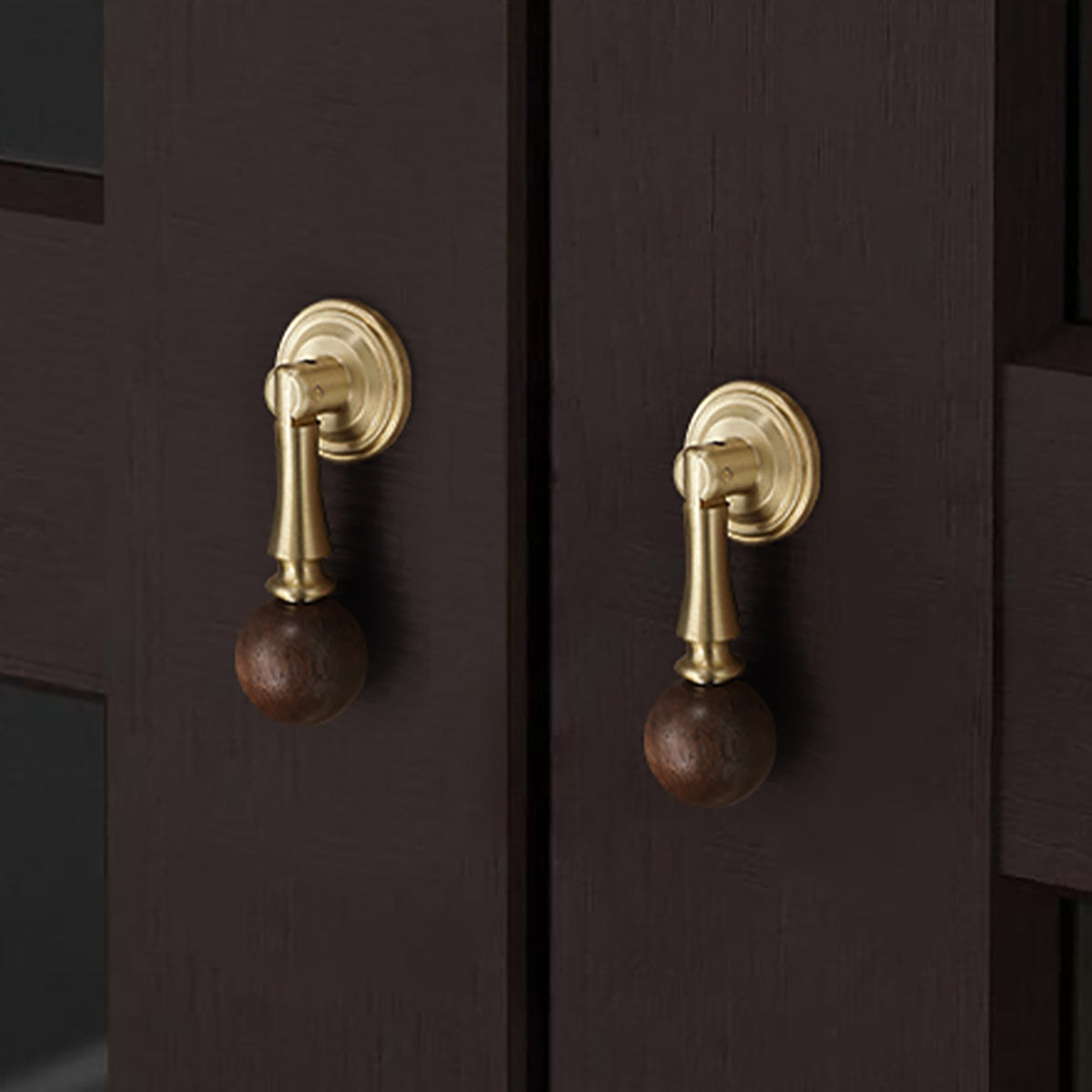 In-use view of brass drop pull with dark wood ball end, style #4 Brass.