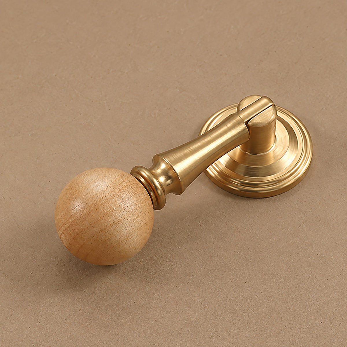 Side and mounting view of light wood ball drop pull with a brass stem and round base, style #5.