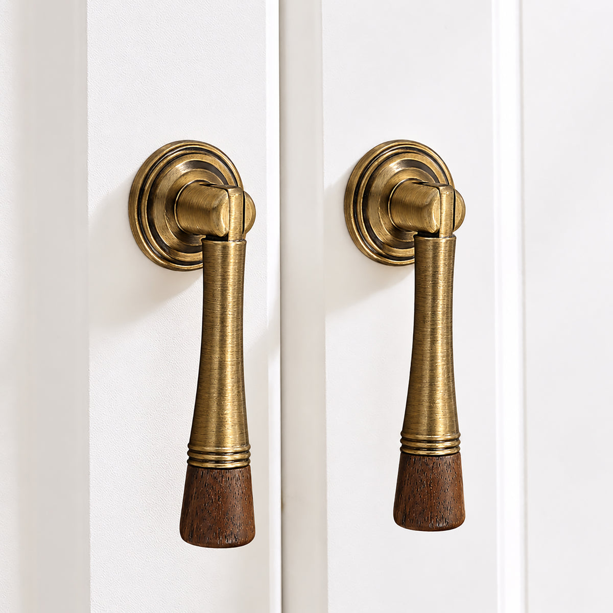 In-use view of dark wood-ended bronze-finish drop pull with round mounting plate, style #7 Bronze (76 mm).