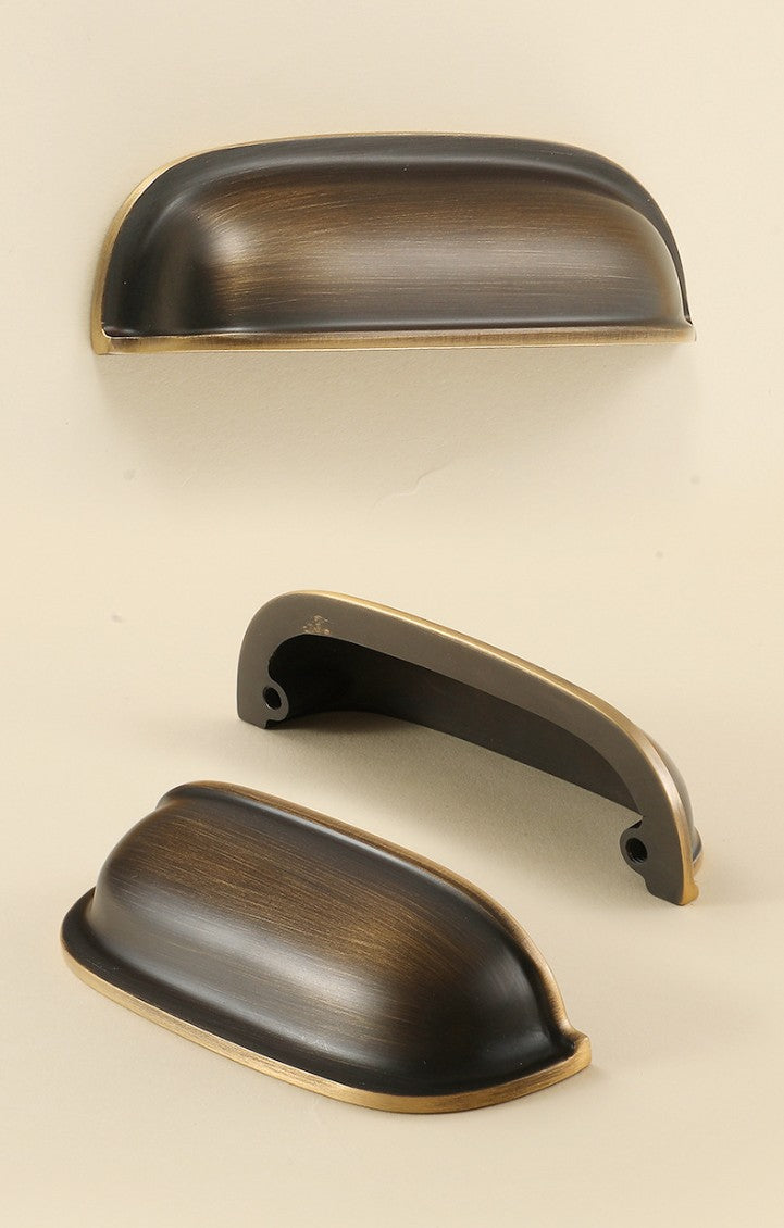 Front, rear and angled views of the solid brass rounded dome cup pull in Antique Bronze.
