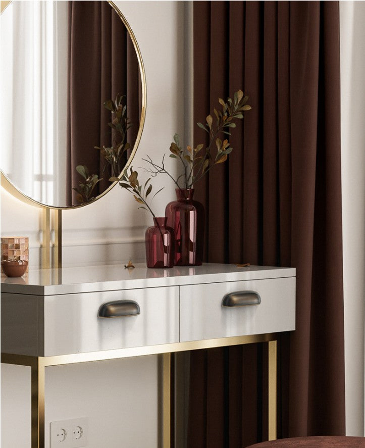 Solid brass rounded dome cup pulls in Antique Bronze on white dressing-table drawers beneath a round mirror.
