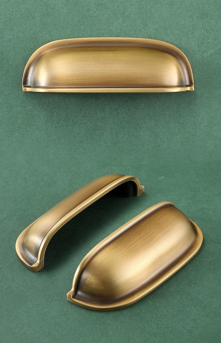 Front, underside and angled views of the solid brass rounded dome cup pull in Burnished Brass.
