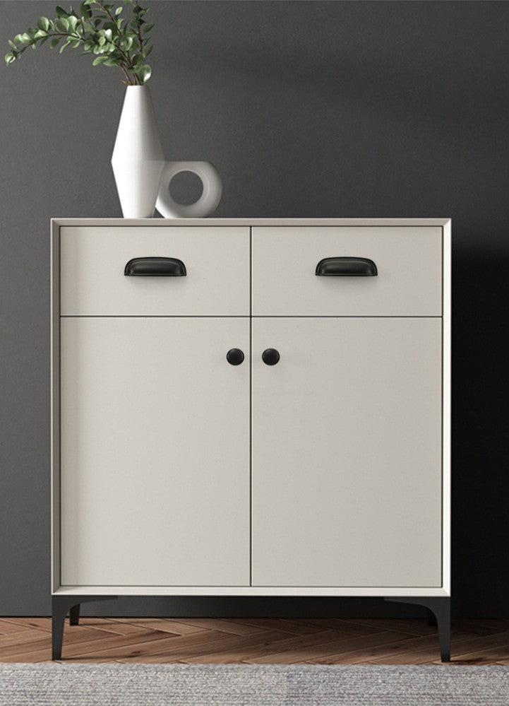 Solid brass rounded dome cup pulls in Matte Black on the drawers of a light-colored cabinet.