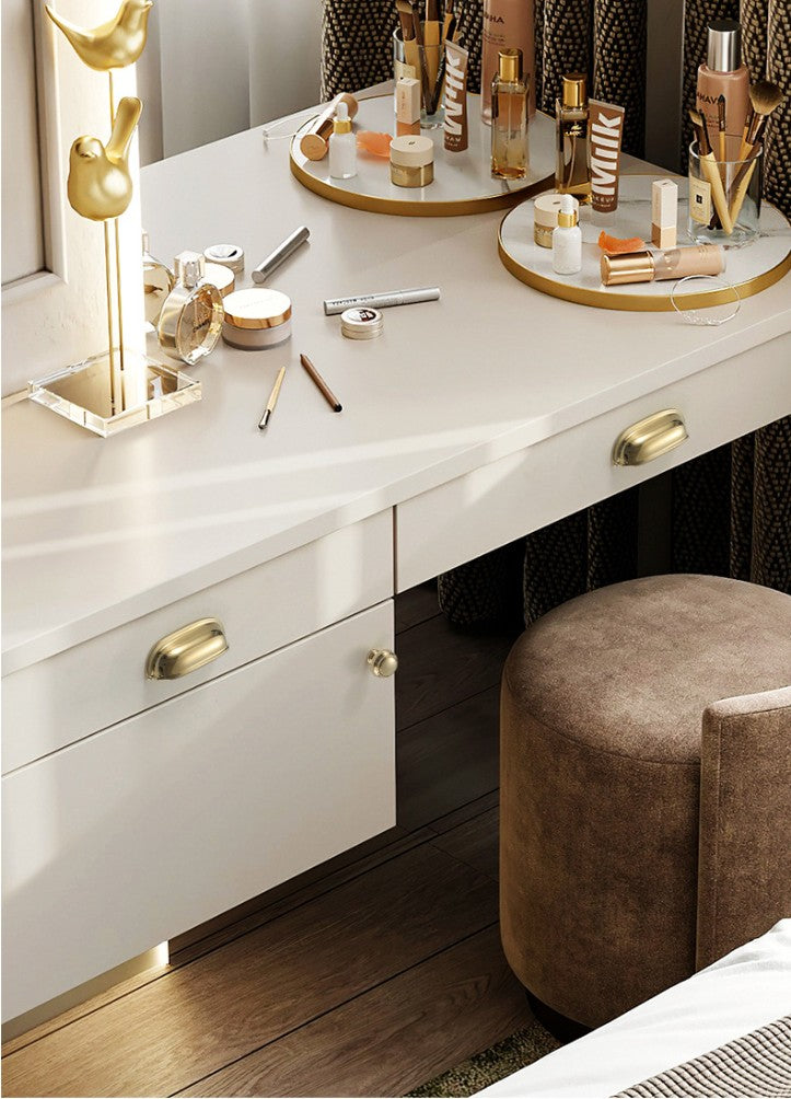 Solid brass rounded dome cup pulls in Polished Gold on white dressing-table drawers.