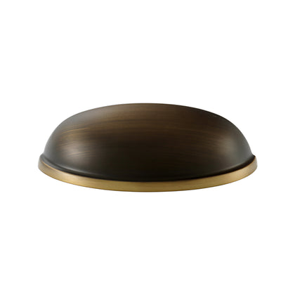 Solid brass half-moon cup pull in antique bronze, angled front view showing its brass-toned rim.