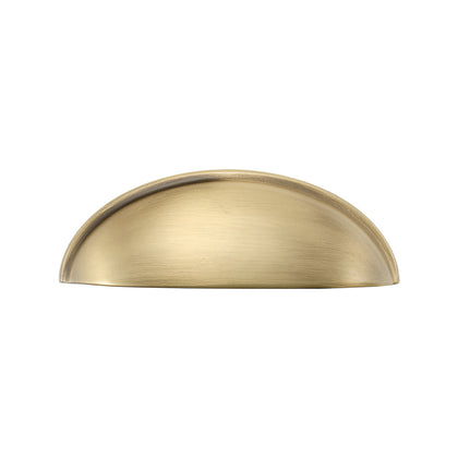 Solid brass half-moon cup pull in burnished brass, front view on white.