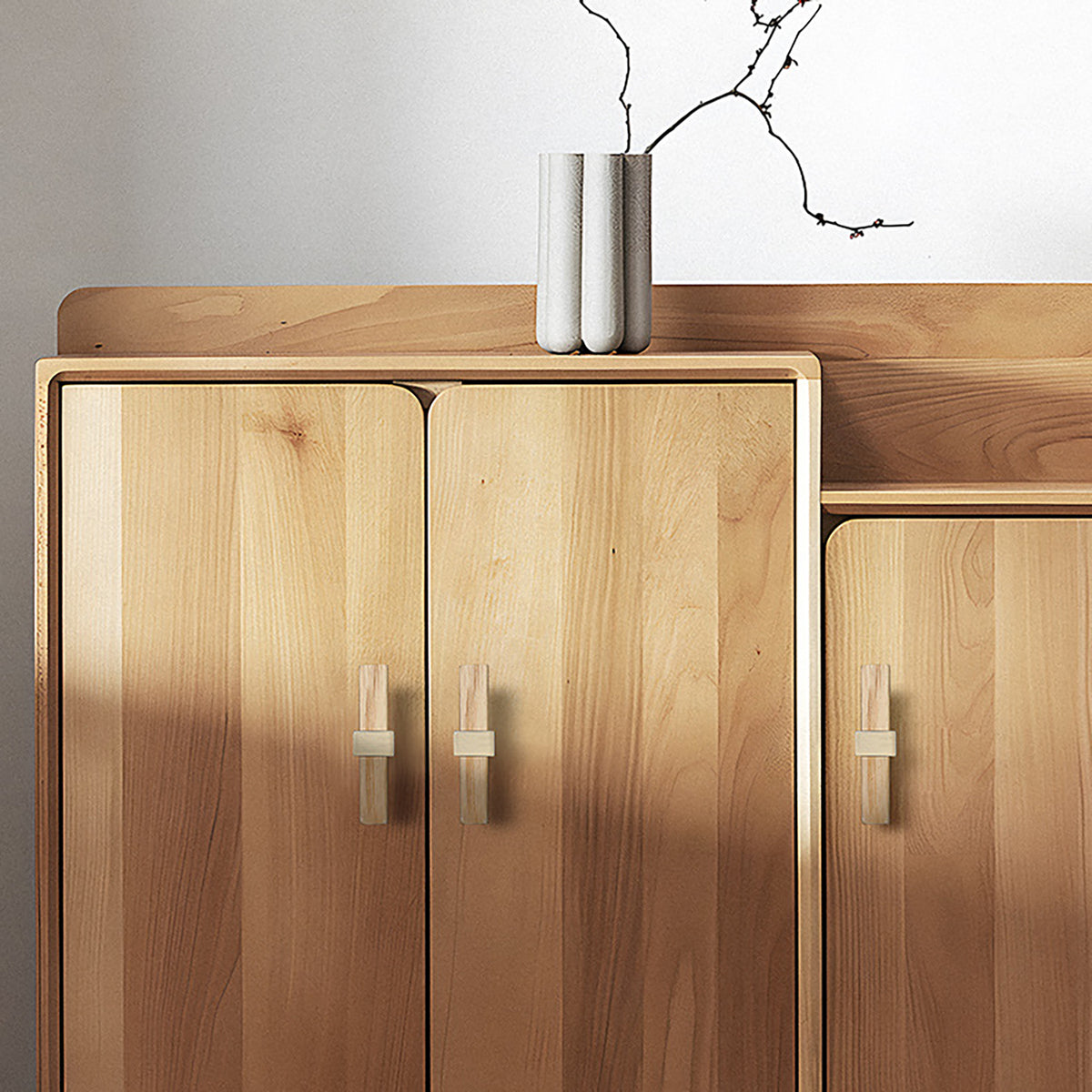 In-use view of oak wood T-bar cabinet pull with a square brass center mount, style #2.